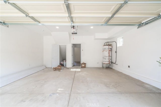 garage with water heater and a garage door opener