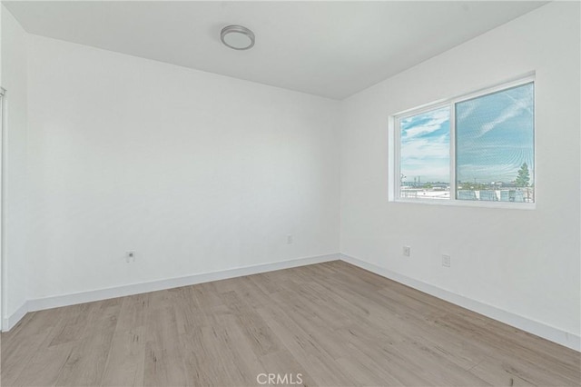 empty room with light hardwood / wood-style floors