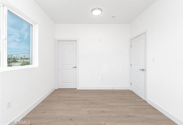 spare room with light hardwood / wood-style floors