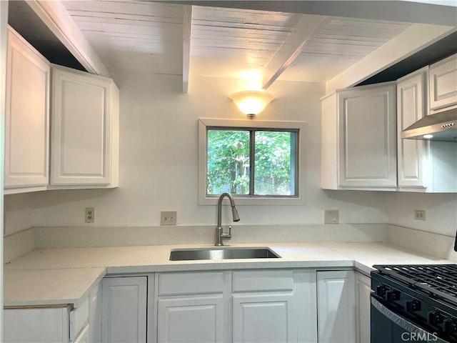 kitchen featuring wooden ceiling, sink, white cabinetry, and beam ceiling