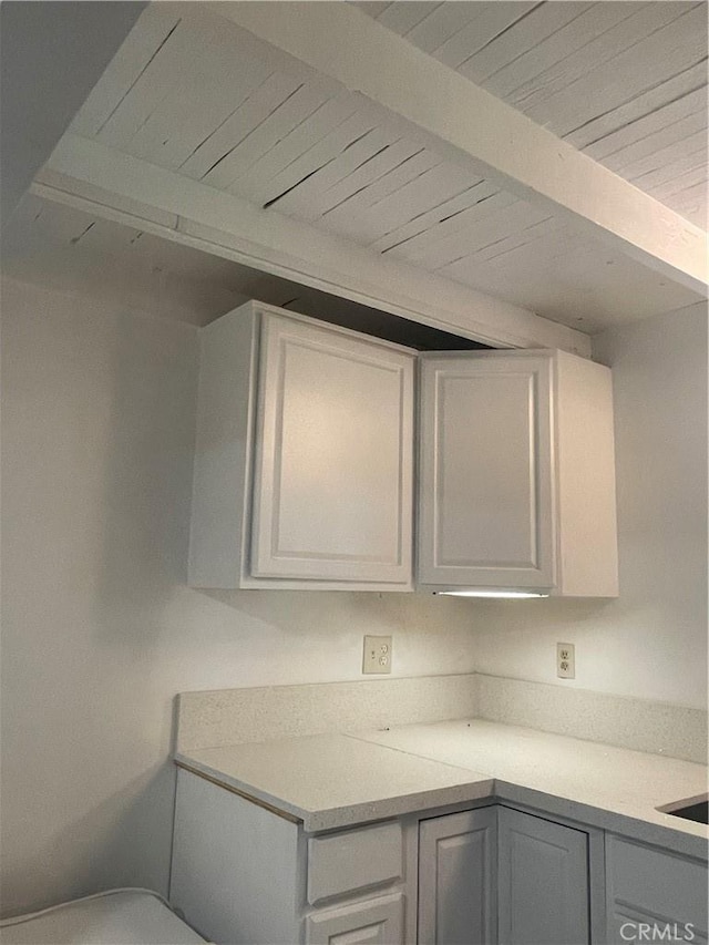 kitchen featuring wooden ceiling and beam ceiling