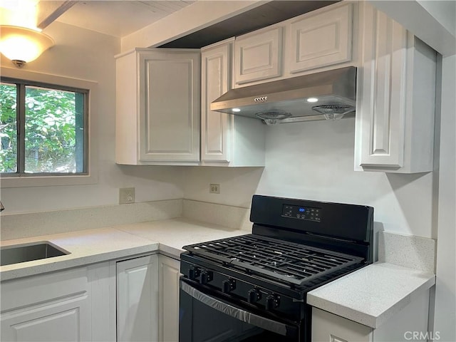 kitchen featuring sink, white cabinetry, exhaust hood, and gas stove