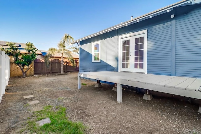 view of property exterior with french doors and a deck