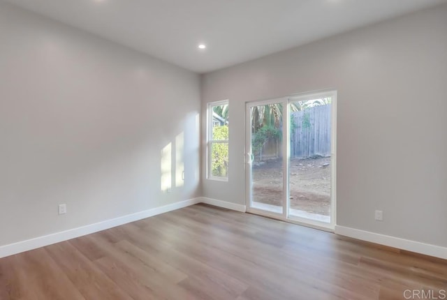 unfurnished room with light hardwood / wood-style flooring