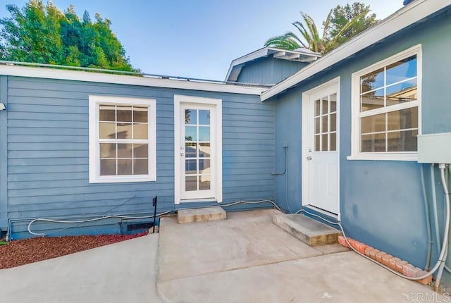 property entrance featuring a patio