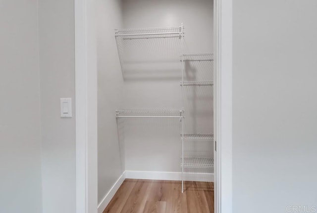 spacious closet with light hardwood / wood-style floors