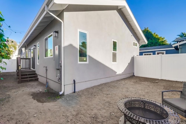 rear view of house featuring an outdoor fire pit