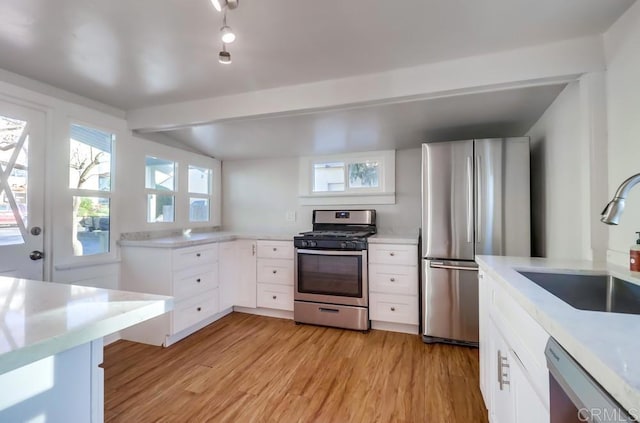 kitchen with sink, white cabinetry, appliances with stainless steel finishes, and light hardwood / wood-style flooring