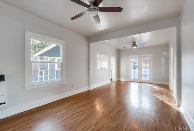 spare room with ceiling fan, french doors, and a wealth of natural light