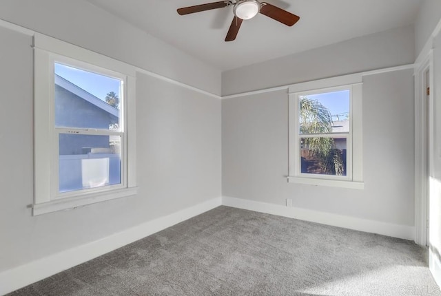 unfurnished room featuring ceiling fan and carpet flooring