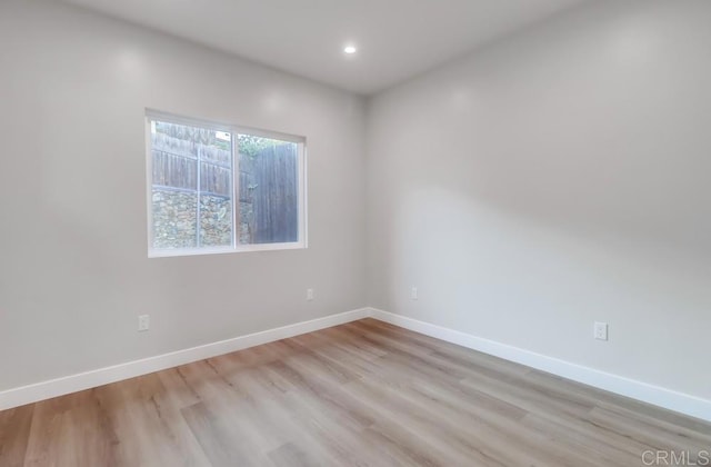 empty room with light hardwood / wood-style flooring