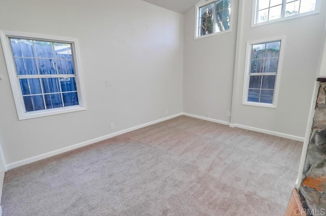 carpeted empty room with plenty of natural light