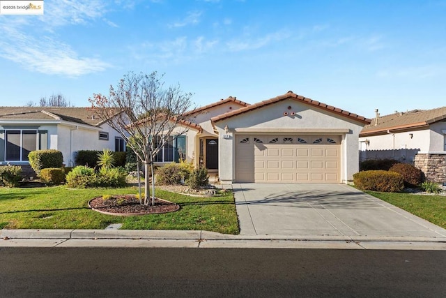 view of front of home with a front lawn and a garage