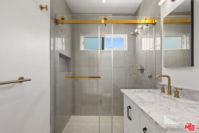 bathroom with an enclosed shower and vanity