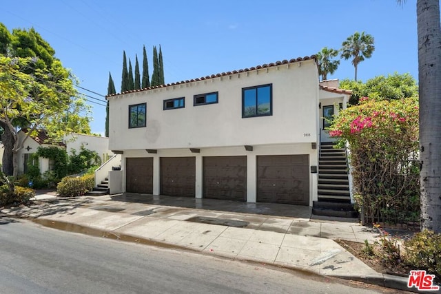 mediterranean / spanish house with a garage