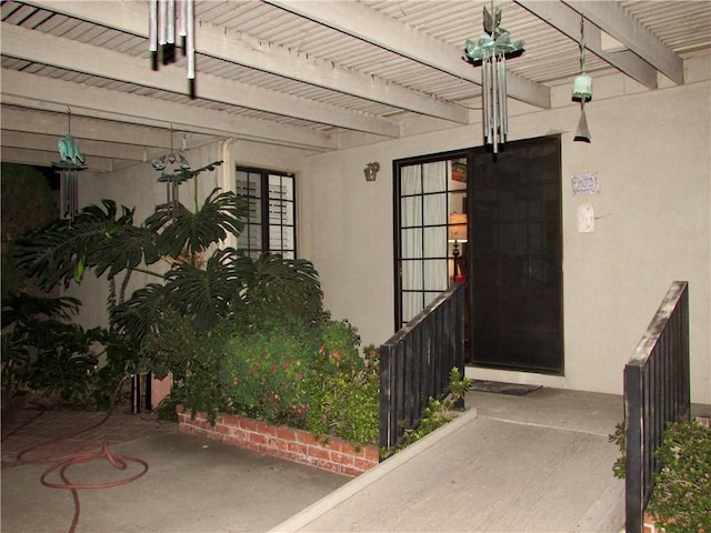 entrance to property featuring a pergola