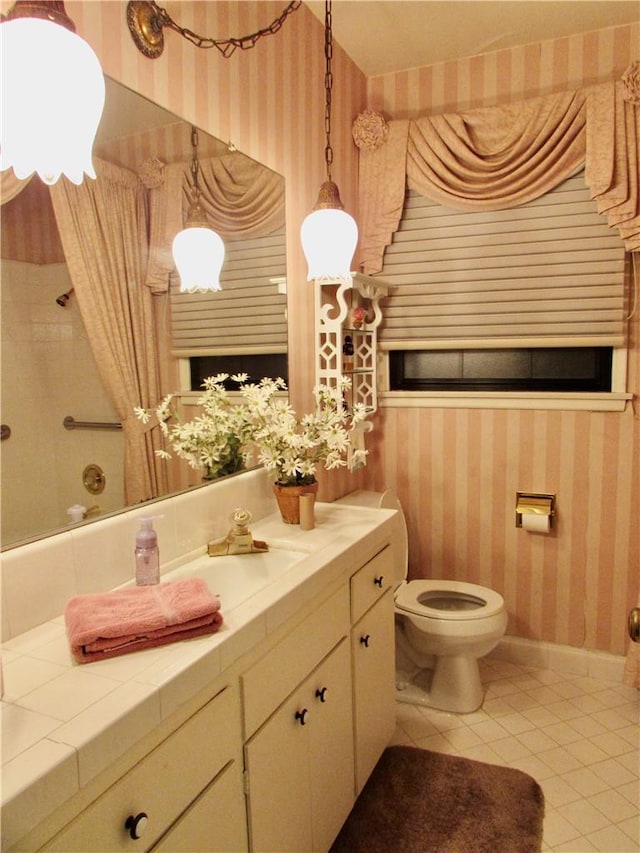 bathroom with tile patterned floors, vanity, and toilet