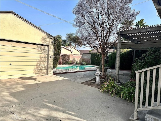 view of patio with a pergola and a garage