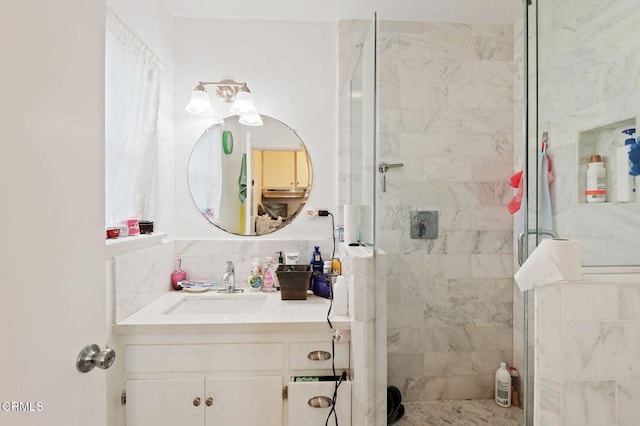 bathroom with walk in shower and vanity