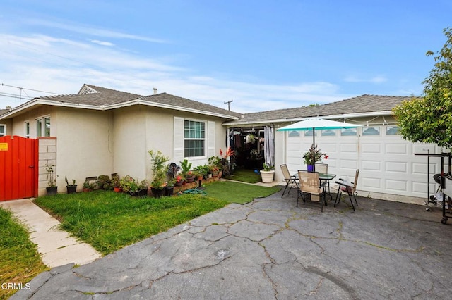 rear view of house featuring a patio area and a lawn