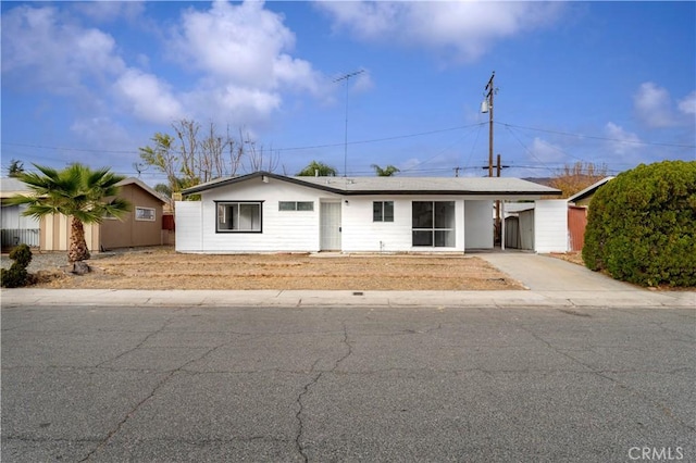 ranch-style house featuring a carport