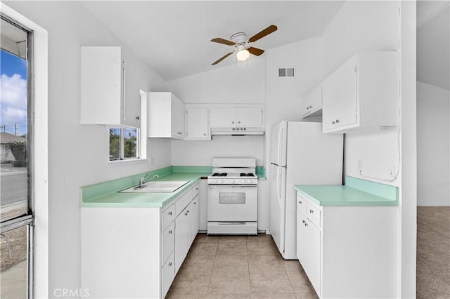 kitchen with white appliances, white cabinets, sink, vaulted ceiling, and ceiling fan