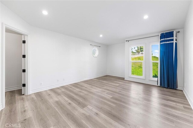 spare room featuring light hardwood / wood-style flooring