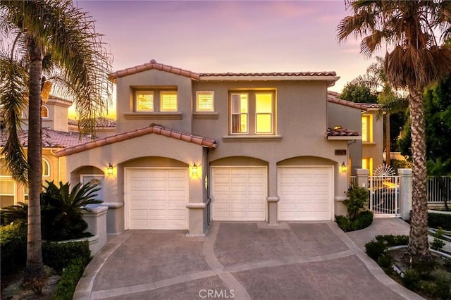 mediterranean / spanish-style house with a garage