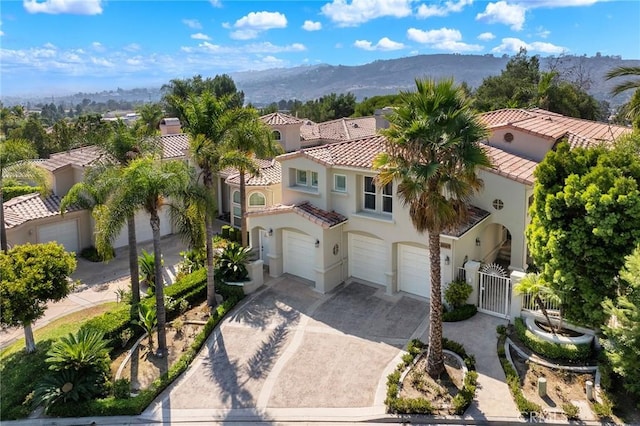 view of front of property with a garage and a mountain view