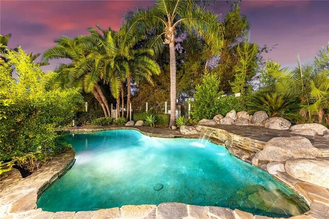 view of pool at dusk