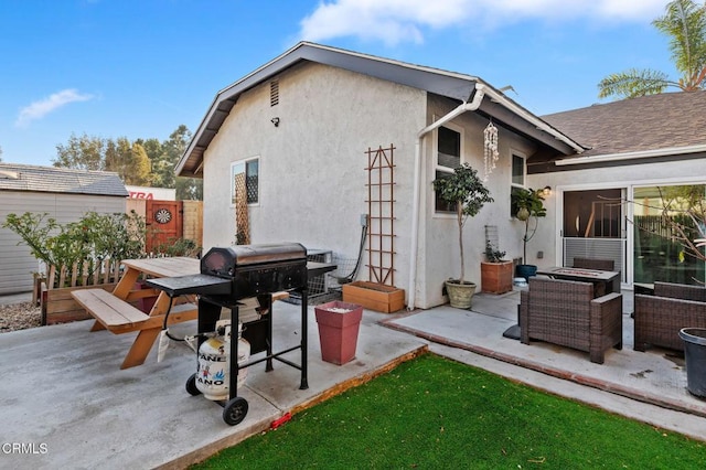 rear view of property with an outdoor hangout area and a patio