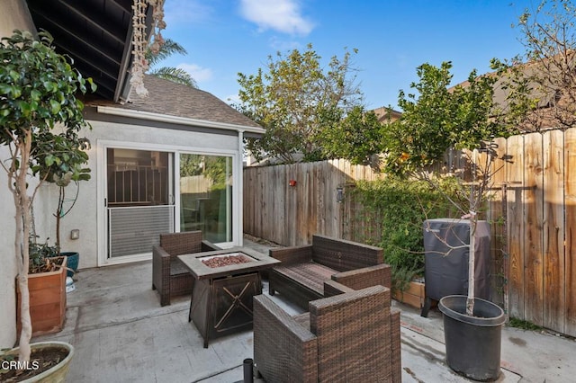 view of patio featuring an outdoor living space with a fire pit