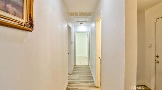 corridor with light hardwood / wood-style floors