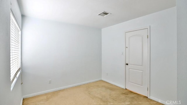 unfurnished room with light colored carpet