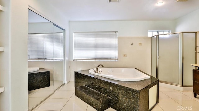 bathroom featuring vanity, tile patterned floors, and shower with separate bathtub