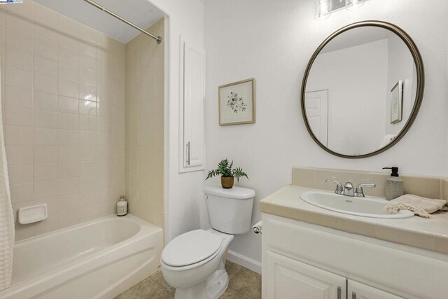 full bathroom featuring toilet, tiled shower / bath, tile patterned floors, and vanity