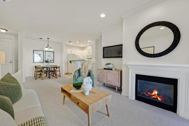 carpeted living room with crown molding