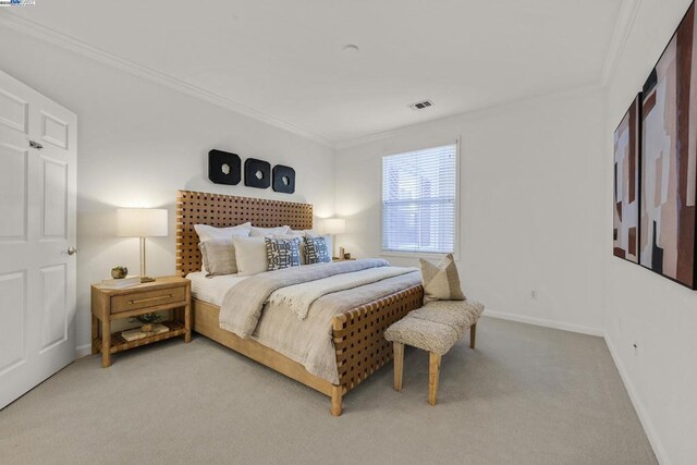 carpeted bedroom with ornamental molding