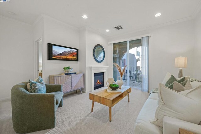 carpeted living room featuring ornamental molding