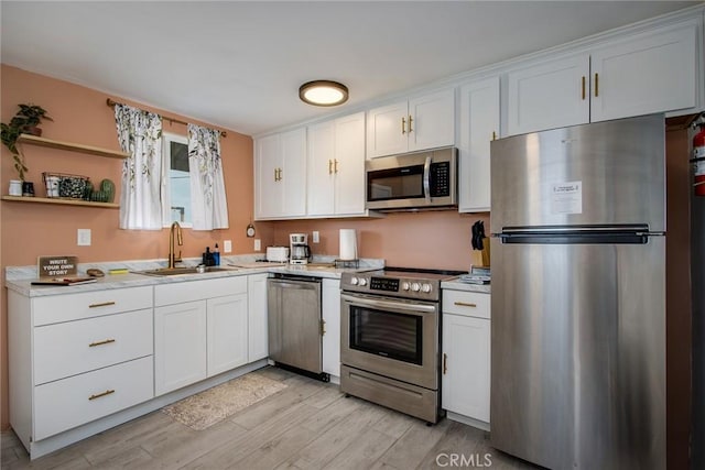 kitchen with appliances with stainless steel finishes and white cabinetry