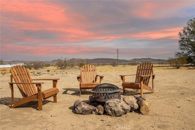 yard at dusk with a mountain view and a fire pit