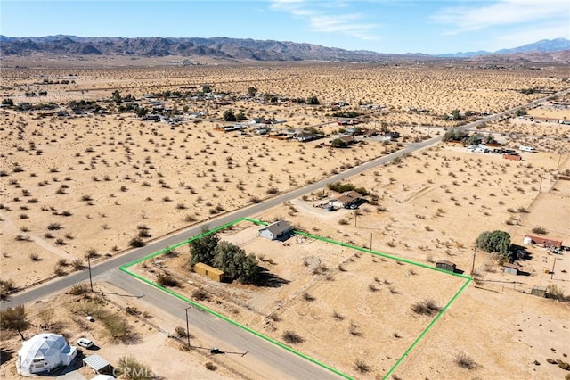 birds eye view of property with a mountain view