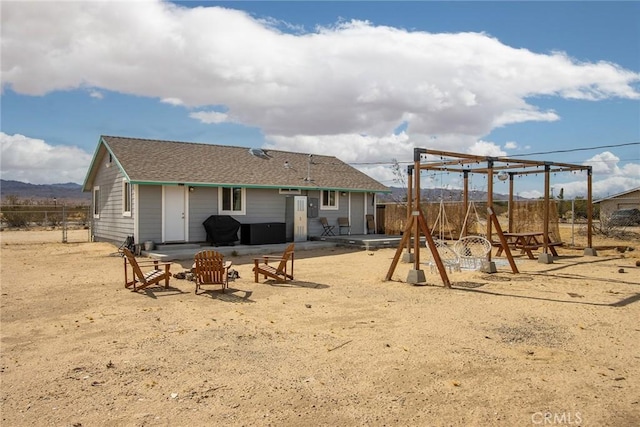 view of playground with a mountain view and a patio