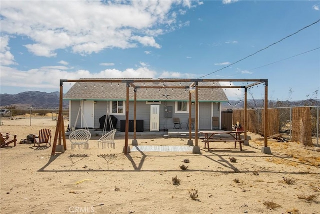 rear view of property featuring a mountain view and a patio