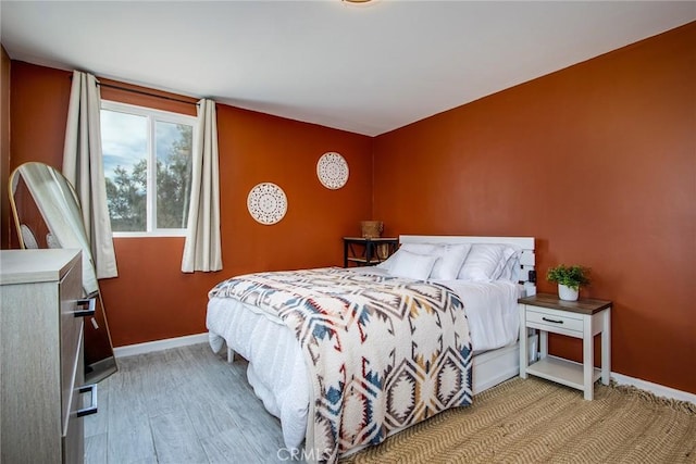 bedroom with light hardwood / wood-style floors