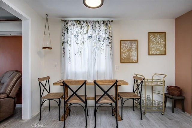 dining space with hardwood / wood-style flooring