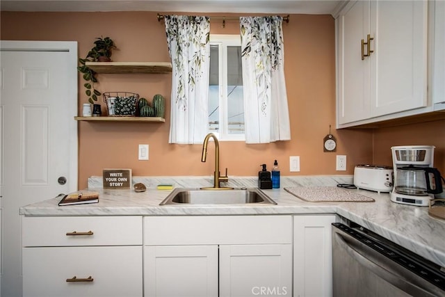 kitchen with dishwasher, sink, and white cabinetry