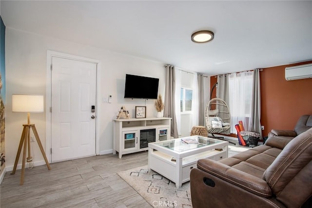 living room with light wood-type flooring and a wall mounted air conditioner