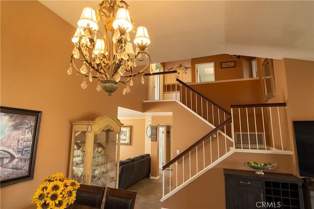 staircase featuring lofted ceiling, a notable chandelier, and tile patterned floors