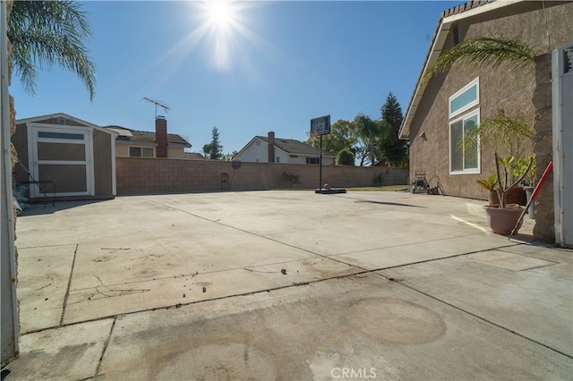 view of patio featuring a storage shed